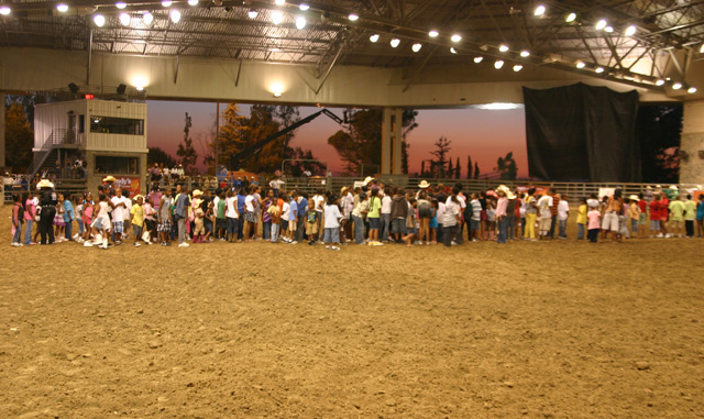 Kids lined up for prizes at Bill Picket Invitational Rodeo