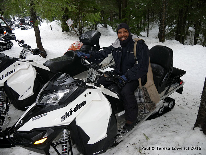 Paul Lowe on a snowmobile, Whistler