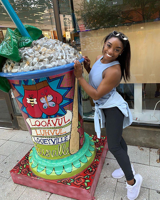 Simone Biles at a sidewalk artwork, Louisville Family Attractions