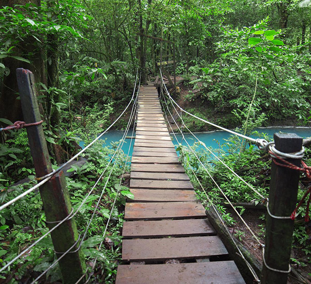 A pedestrian bridge of the Celeste River, Costa Rica Travel Tips