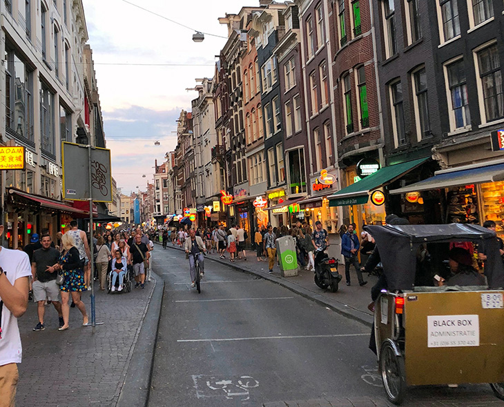 Numerous restaurants and shops in an Old Amsterdam street