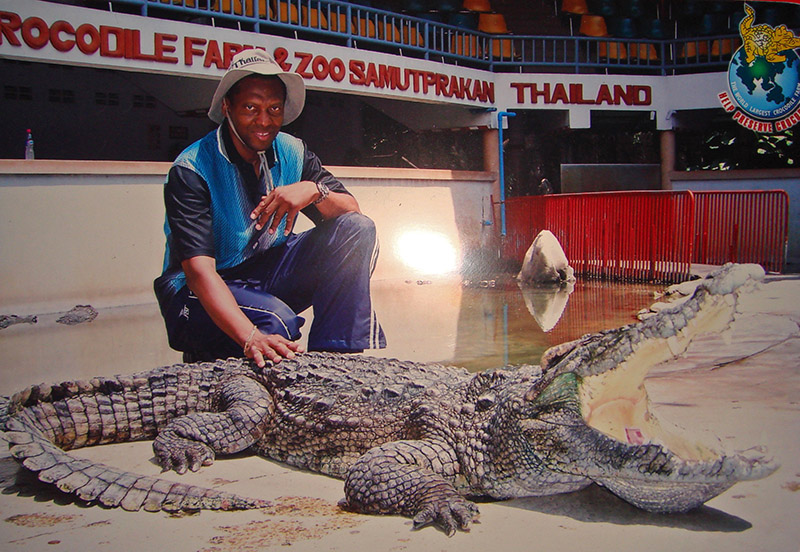 Robert Goldston petting a real crocodile in Bangkok