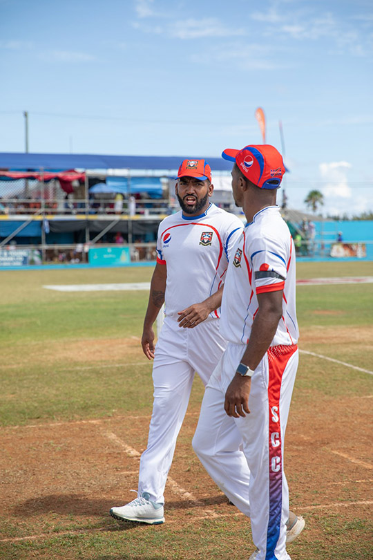 Cricket teammates discuss tactics in Bermuda
