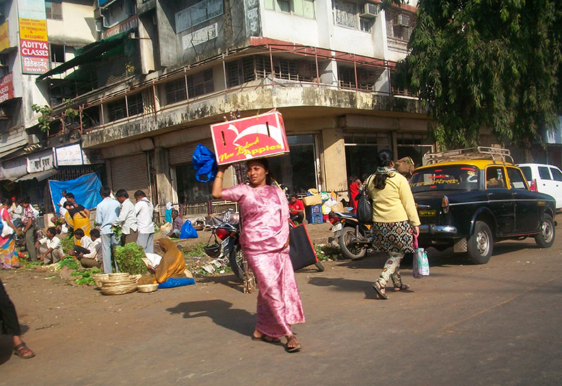 Lady coming from a street market in Mumbai