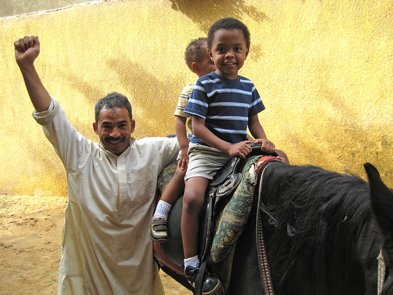 Archie kids riding a donkey in Luxor
